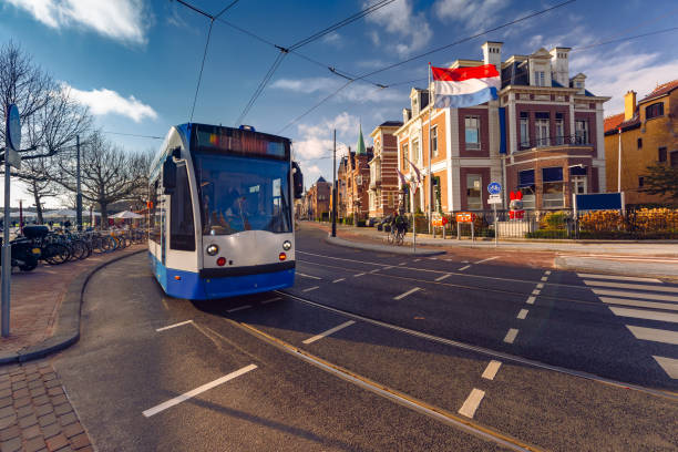 istock Amsterdam tram, flag and dutch houses 1399573730