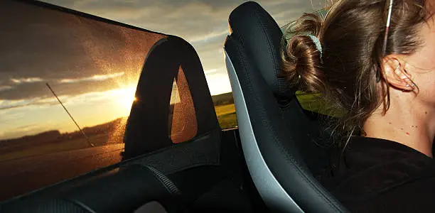 woman is driving a mercedes SLK