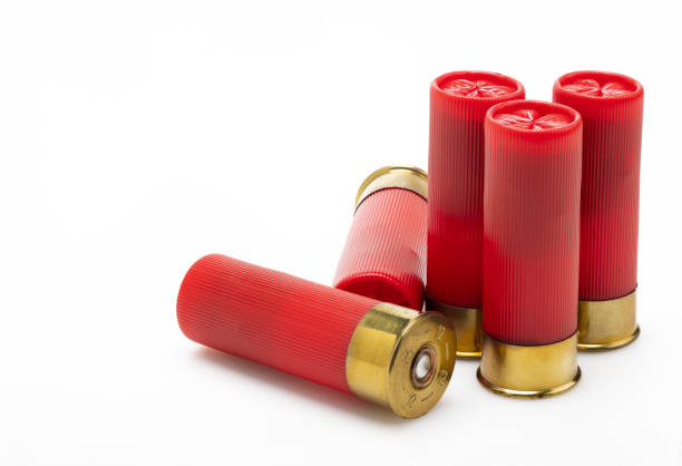 istock Red shotgun bullet shells on white background , Gun shooting game 1399579822