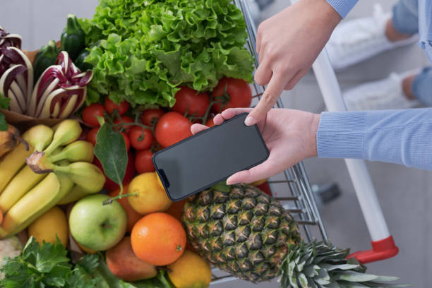 istock Woman buying fresh greens and using her smartphone 1399579900