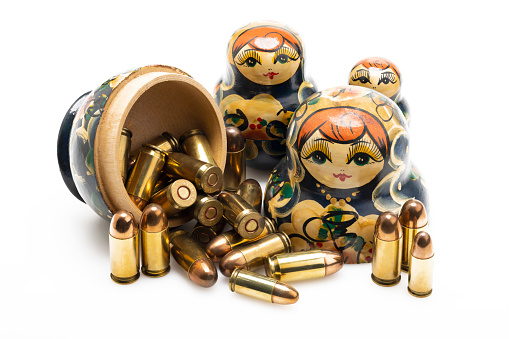 Russia dolls and many gun bullets on white background , Stop the war concept