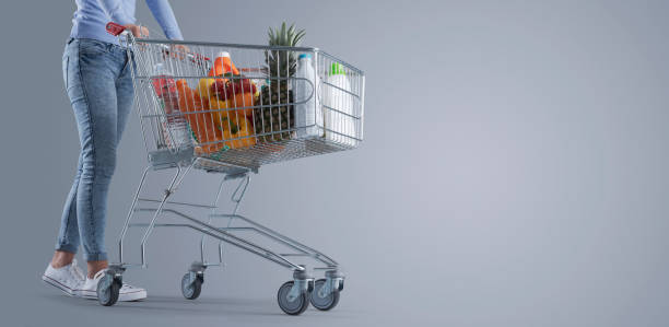 istock Woman pushing a full shopping cart 1399579949