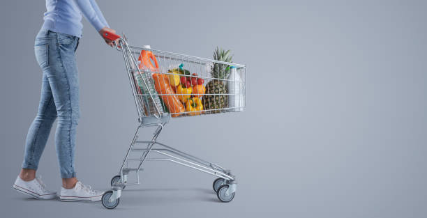 istock Woman pushing a full shopping cart 1399579987