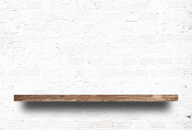 istock Brown wood shelf on a white brick wall background. 1399580125