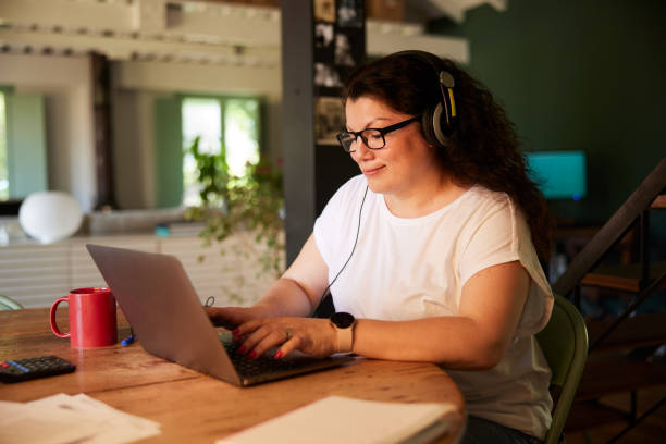 istock A woman working from home at the dining table. 1399581197