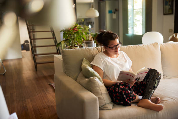 istock A disabled woman reading and relaxing at home 1399581302
