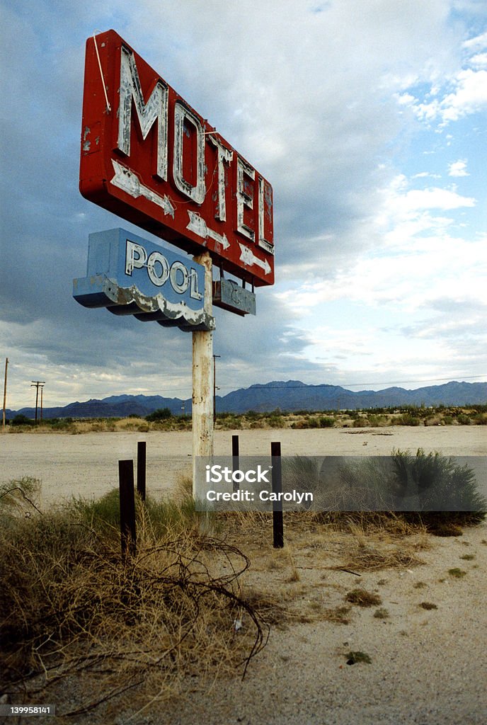 Motel and Pool Sign in Desert Sign for Motel and Pool that no longer exist, pointing to barren desert. Motel Stock Photo
