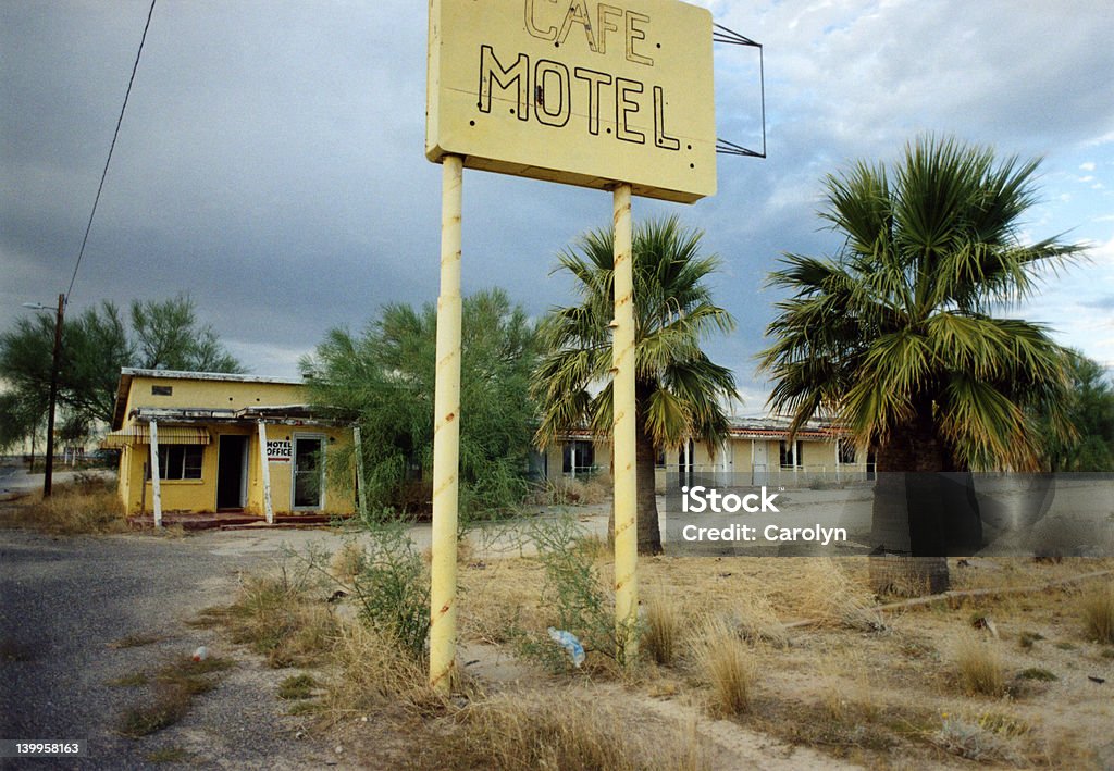 Yellow Cafe Motel Abandoned cafe and motel in the desert in Yucca, Arizona, painted yellow with overcast sky. Abandoned Stock Photo