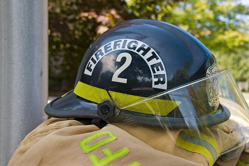 Close up of firefighters helmet on brown coat