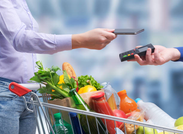 istock Woman paying for groceries using her smartphone 1399582840