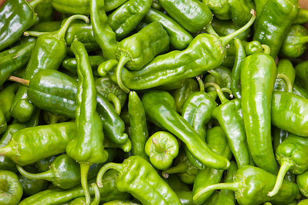 A closeup of many green hot chili peppers a basket of green chili peppers from farmers market green chilli pepper stock pictures, royalty-free photos & images