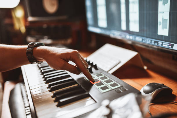 istock Producer Hitting Great Drum Beats On MIDI Keyboard In Studio 1399588638