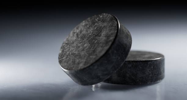 Hockey pucks on ice closeup
