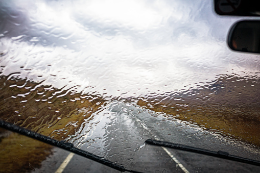 Windscreen wipers fighting to keep the rain away on a winter journey through Glencoe in Scotland.