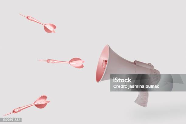 Copper Arrows And Beige Gunmegaphone On Isolated Pastel Background With Copy Space Minimal Abstract Creative Concept Of Hate Killing Speech Fake News Hurtful Words Or Warmongering Rhetoric Stock Photo - Download Image Now