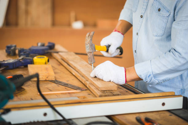 istock Craftsman using hammer hobnailed in workshop, Carpenter using the hammer hit a nail for assembly wood in a carpentry workshop 1399591665