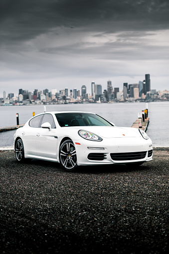 Seattle, WA, USA\n5/25/2022\nPorsche Panamera parked next to water with Seattle in the background