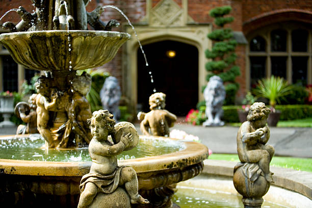 A lovely arrangement of playing cherubins around a water fountain make a great backdrop to a wedding location venue.