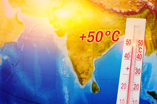 Thermometer with a record high temperature of fifty degrees Celsius, against the backdrop of the continent of the Indostan subcontinent. Hot weather concept.