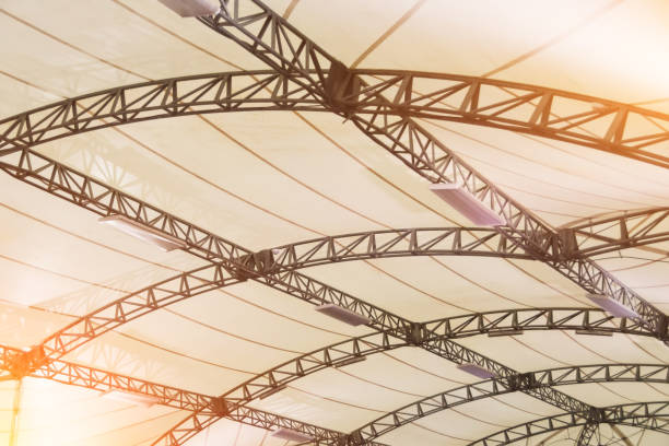 istock Arched metal frame tent with white coated fabric material, with interior lighting lamps. 1399595324