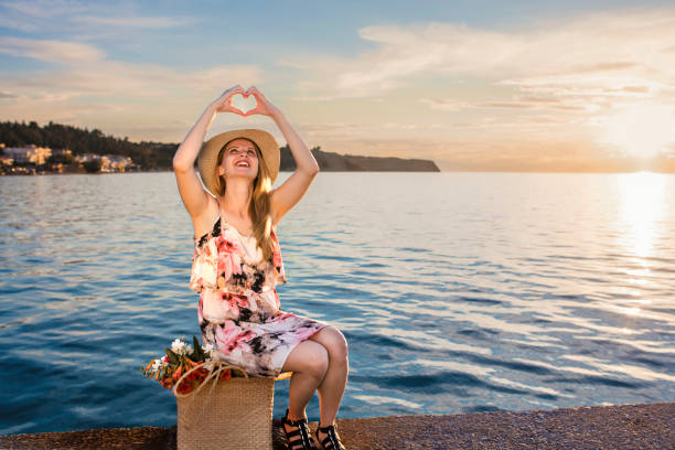 Woman relaxing by the seashore at sunset