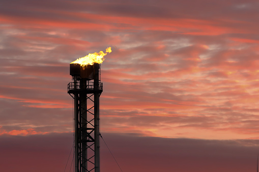 Gas plant flaring at a gas terminal showing non renewable energy (dirty energy)