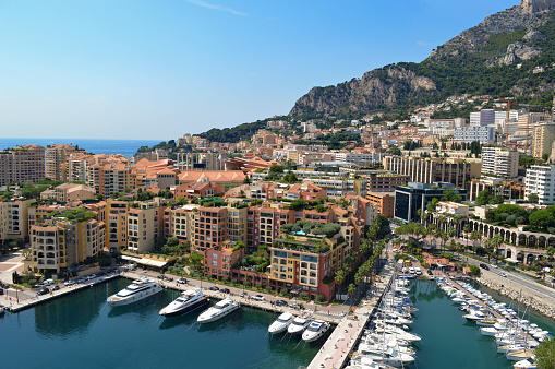 Summer landscape of Monaco. Aerial view. View of Skyline, Port de Fontvieille in Monaco, Monte Carlo. Many luxury yachts and mountains in the background.