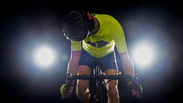 istock Back lit road bike cyclist isolated on a black 1399599901
