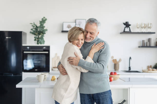 istock Married couple dancing and hugging in kitchen 1399600215