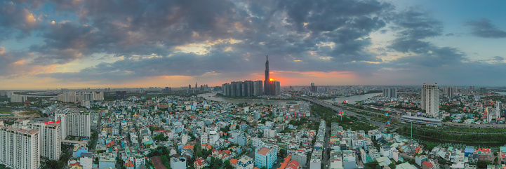 Aerial sunset view at Landmark 81 - it is a super tall skyscraper and Saigon bridge with development buildings along Saigon river light smooth down. Travel and landscape concept.
