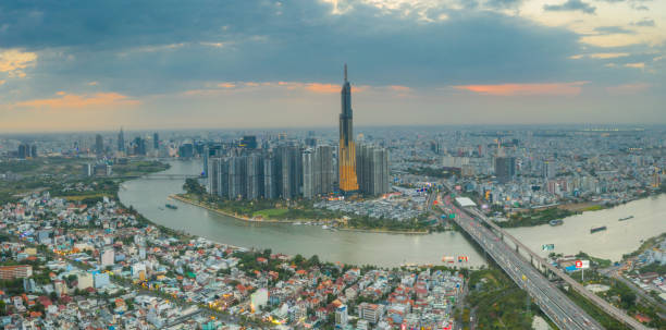 istock Aerial sunset view at Landmark 81 - it is a super tall skyscraper and Saigon bridge with development buildings along Saigon river light smooth down. 1399601691