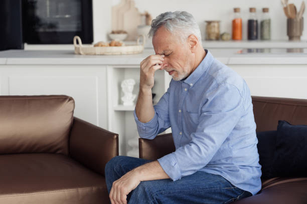 istock Senior man feeling sick, touching nose bridge 1399601812