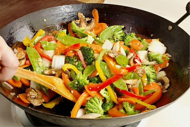 Chinese food stirfry Asian-style stir-fry vegetables cooking in a wok sauteed stock pictures, royalty-free photos & images