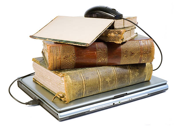 istock Laptop topped with books with computer mouse topping like 139960301