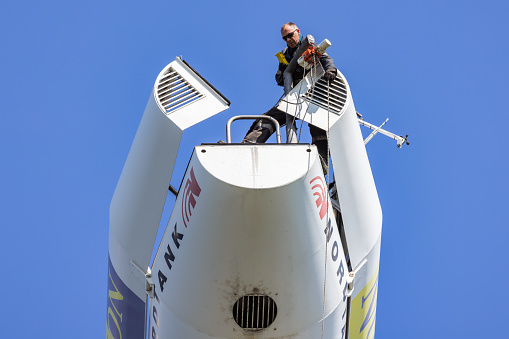 Lelystad, The Netherlands - April 22, 2022: Construction worker busy with maintenance in gondola of wind turbine
