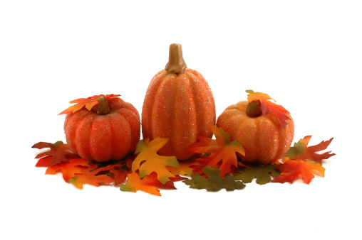 Arrangement of artificial bright pampkins and maple and oak leafs - Thanksgiving