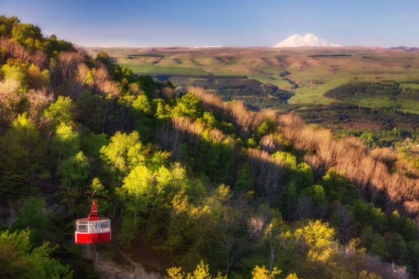 Kislovodsk national park Red cabin of the cable car over the forest of Kislovodsk national park and view of Elbrus stavropol stavropol krai stock pictures, royalty-free photos & images