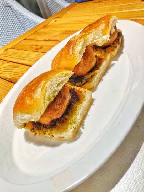 istock Bombay Vada pav (Indian potato burger) with chutney (sauce) served on a white plate 1399609297