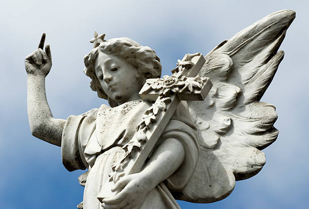 istock Angel carved from marble, pointing to heaven. 139960936