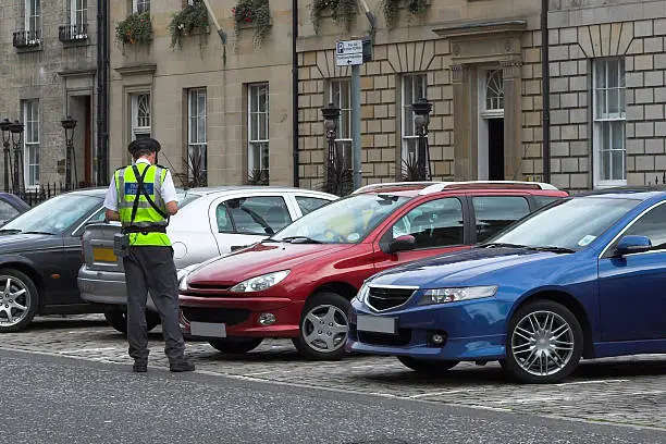 Photo of parking attendant, traffic warden, getting ticket fine mandate