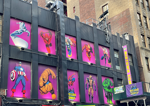 Superhero characters displayed on exterior wall of a Midtown Comics shop in Manhattan.