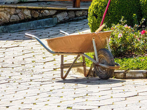 Garden cart (utility wagon) on a garden, on a sunny day.