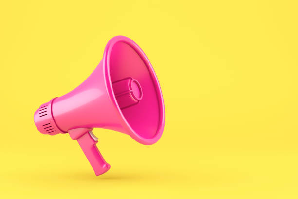 istock Single pink electric megaphone with a handle stands on a yellow background 1399619199