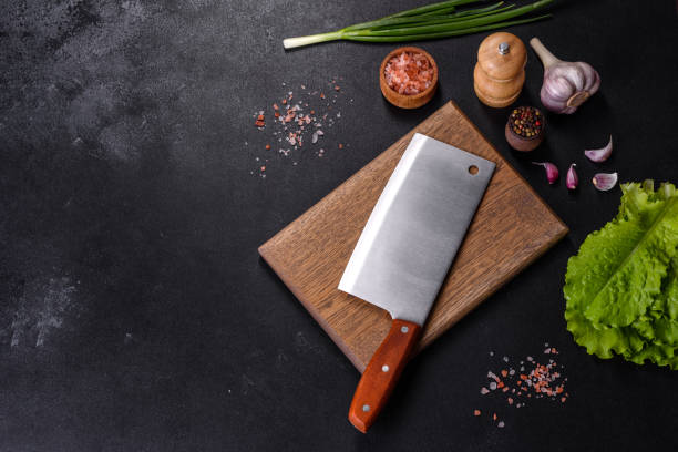istock An axe for meat, spices and herbs, a cutting board against a dark concrete background 1399619353