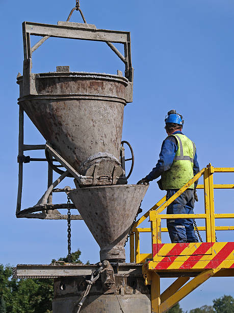 istock Worker pours cement into the well 139961939