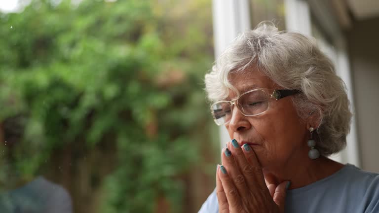 Contemplative senior woman at home