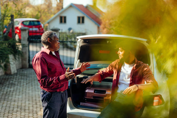 istock Family packing stuff for vacation into car and having conversation 1399621053