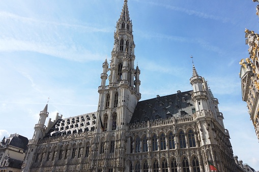 Grand Place in Brussels Belgium and its wonderful Town Hall with a sunny blue sky