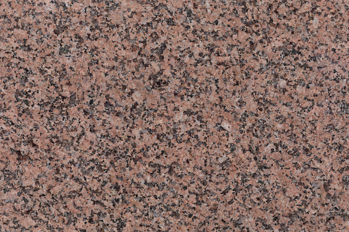 polished section of Granite Igneous rock with distinctive pink feldspar minerals