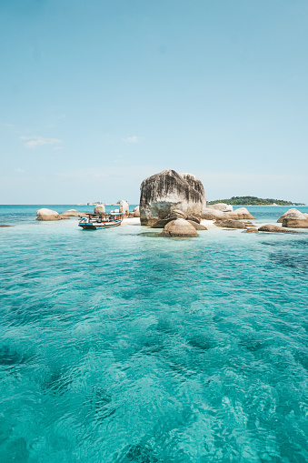 The white sand appears during the low tide. Batu Berlayar Island also features several coral reefs.